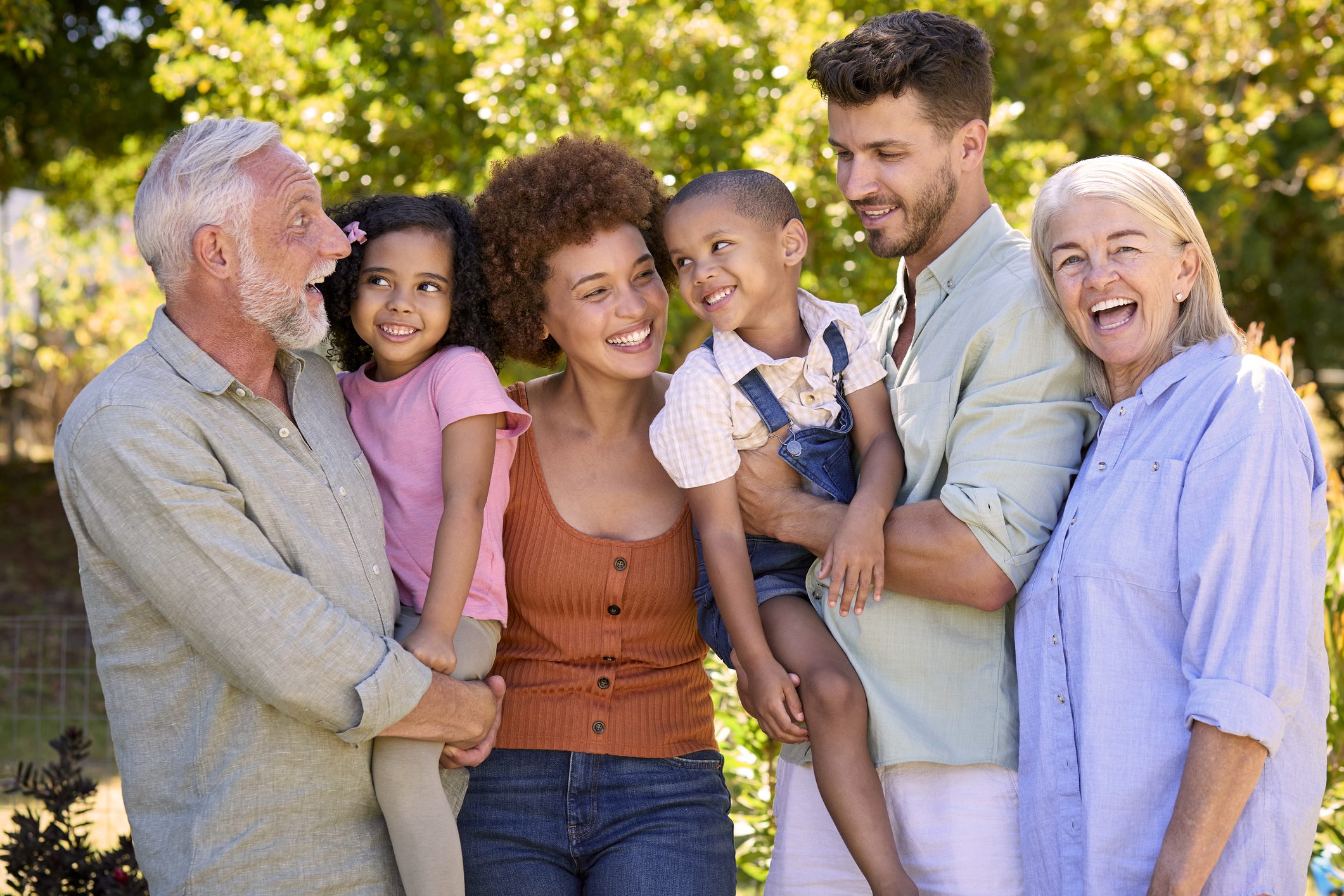 A joyful multigenerational family enjoying time outdoors.
